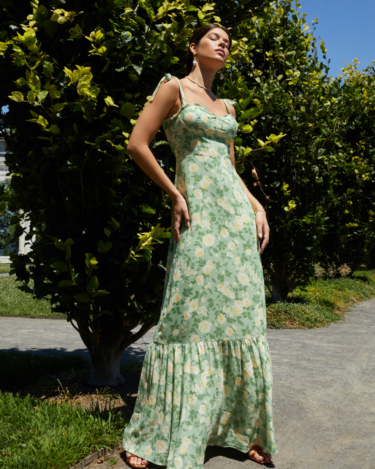 First image of La Rue Dress, a sage floral floor-length bridesmaid dress with adjustable tie straps, cup detail, neckline ruffles, tiered skirt, lining, back smocking and back zipper