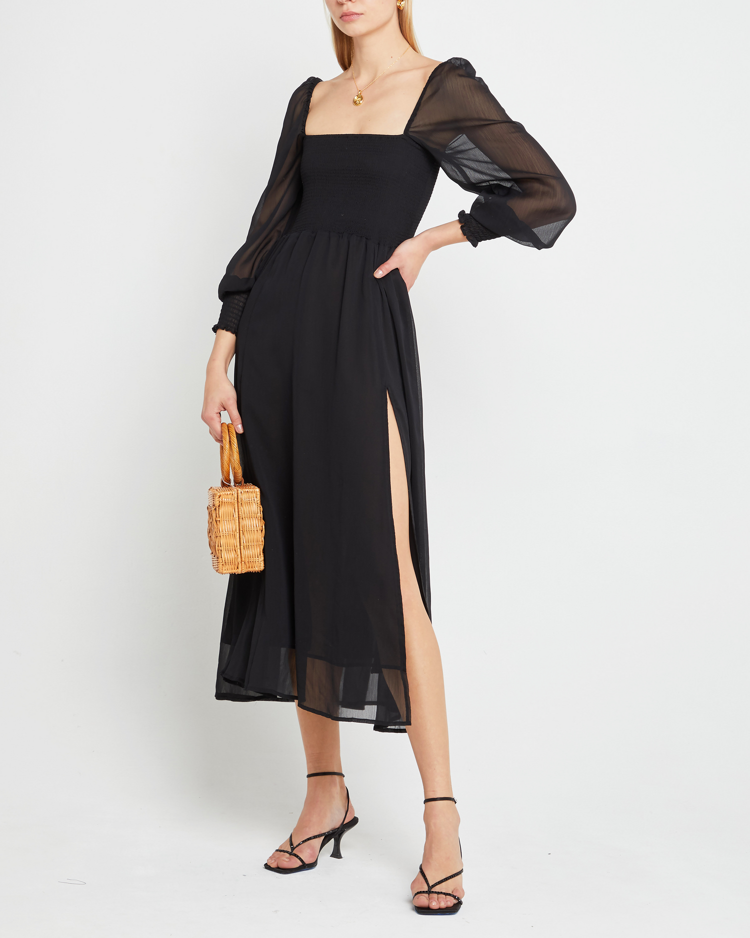 First image of Classic Smocked Maxi Dress, a black maxi dress, side slit, long, sheer sleeves, puff sleeves, suqare neckline, smocke bodice