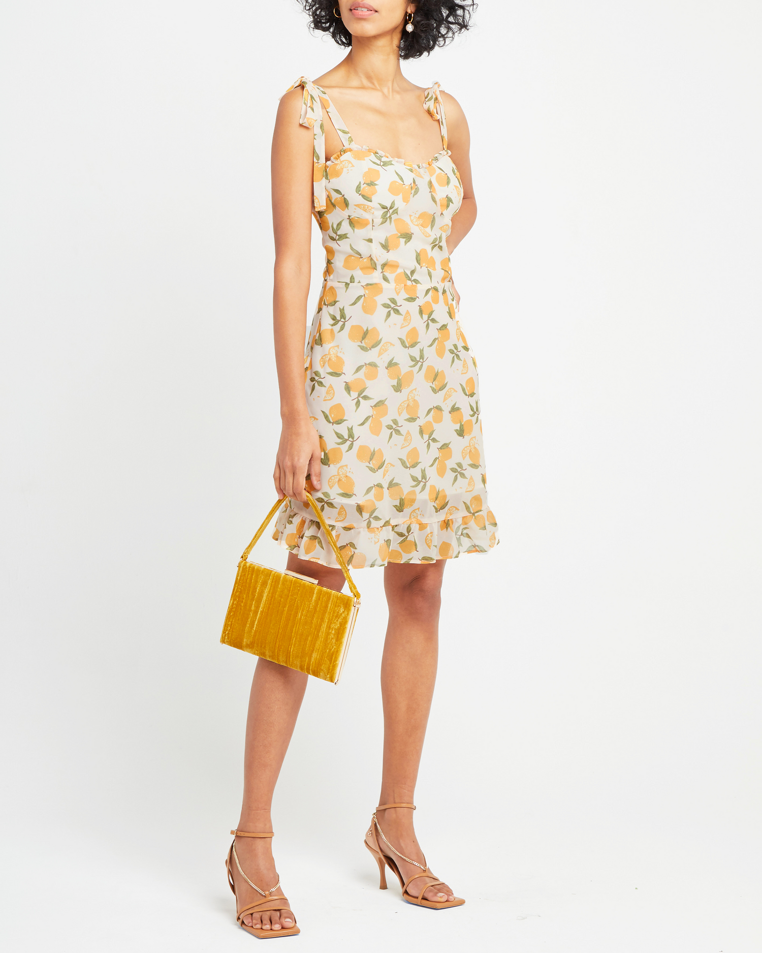 First image of Sunny Dress, a yellow mini dress, ruffle, ribbon, tie straps, ribbon, bows, lemon print