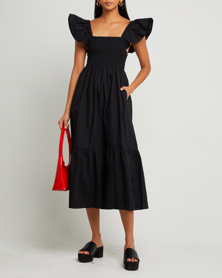 First image of Tuscany Dress, a black maxi dress, smocked bodice, ruffled cap sleeves, pockets
