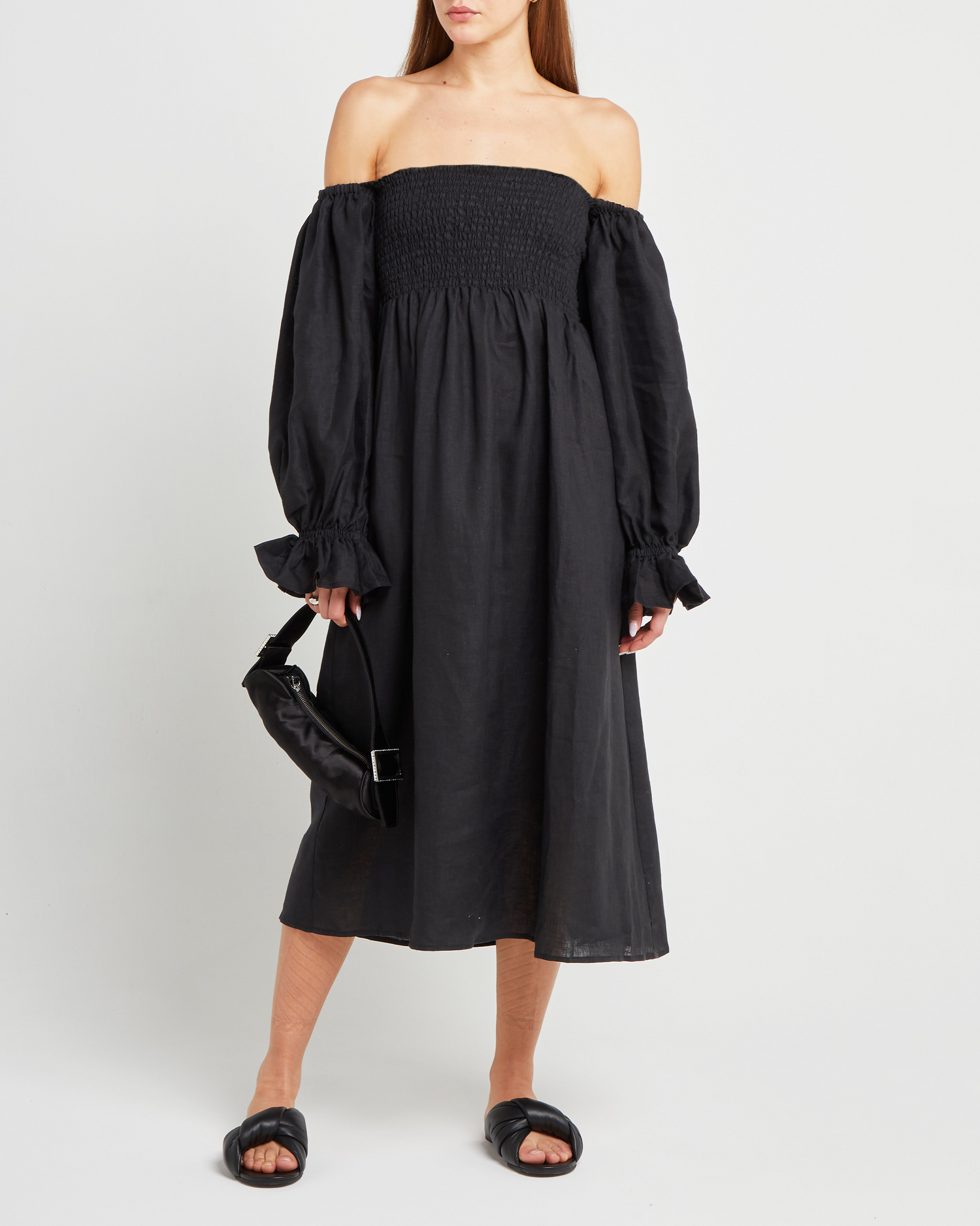 First image of Athena Dress, a black midi dress, off shoulder, long sleeve, puff sleeves, smocked