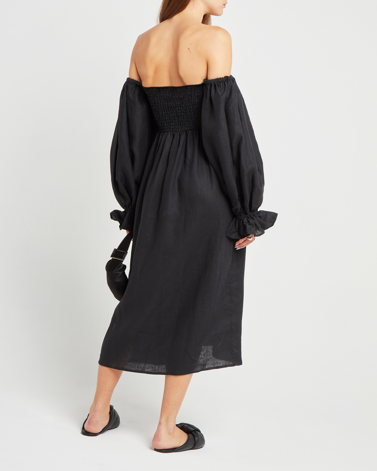 Second image of Athena Dress, a black midi dress, off shoulder, long sleeve, puff sleeves, smocked