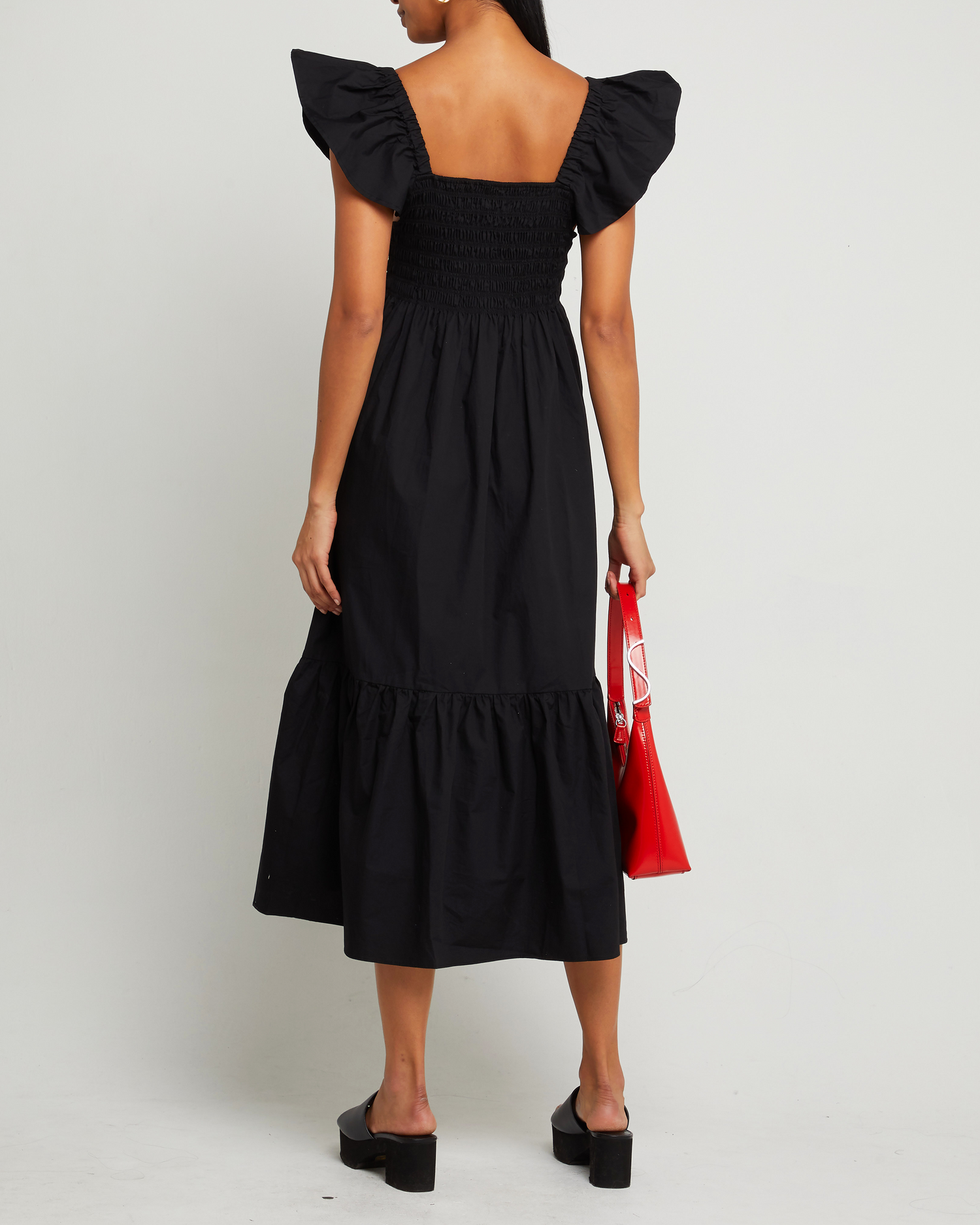 Second image of Tuscany Dress, a black maxi dress, smocked bodice, ruffled cap sleeves, pockets