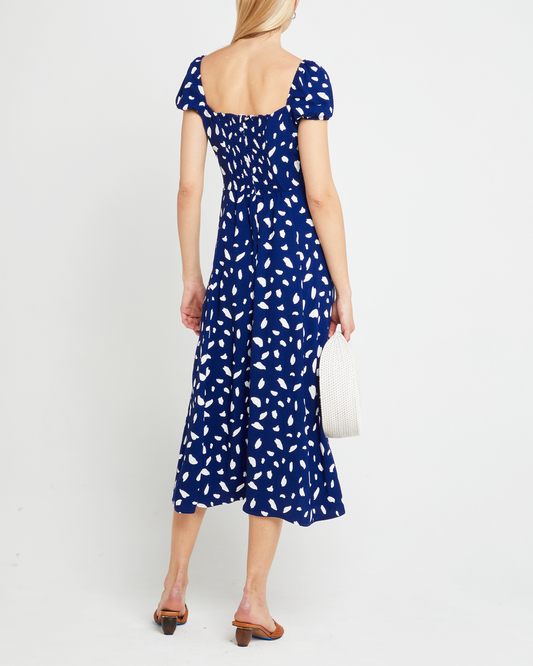 Second image of Cyra Dress, a blue midi dress, white polka dot, cap sleeves, side slit, square neckline
