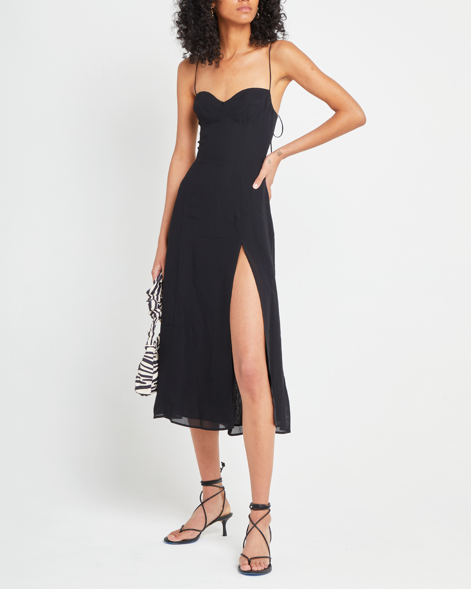 Third image of Venus Dress, a black midi dress, tie straps, spaghetti straps, side slit, bodice