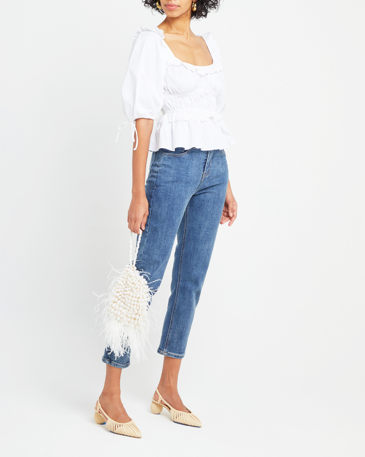 Third image of Snow Hill Top, a white puff sleeve top, lace and ruffle details, peplum-like hem