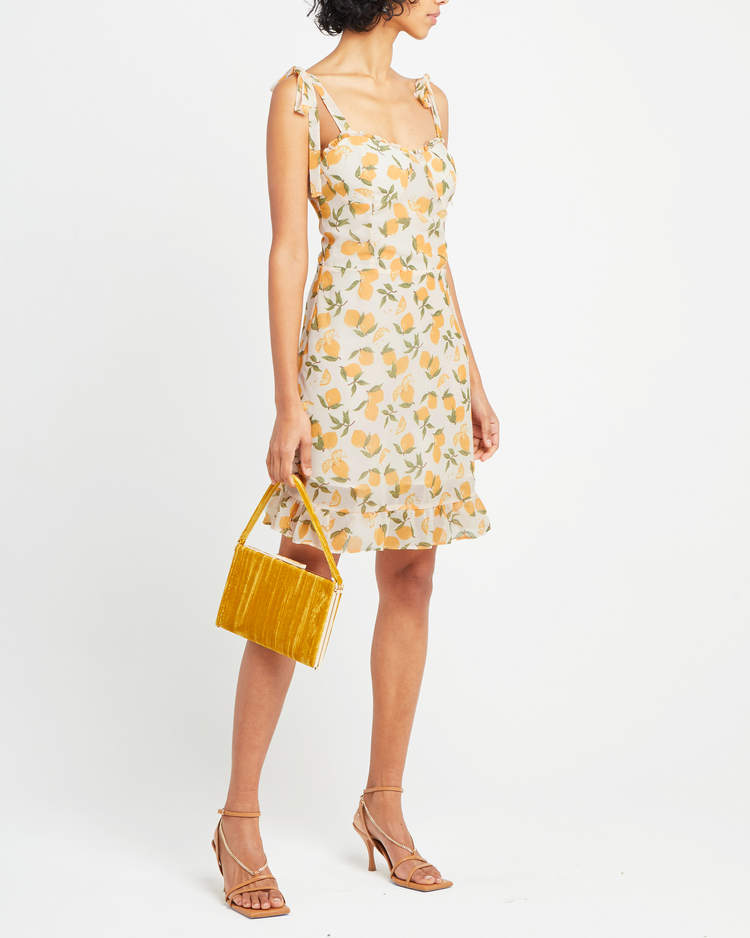 Third image of Sunny Dress, a yellow mini dress, ruffle, ribbon, tie straps, ribbon, bows, lemon print