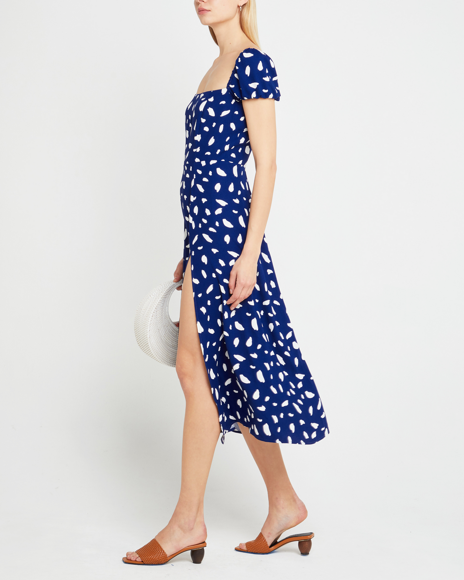 Fourth image of Cyra Dress, a blue midi dress, white polka dot, cap sleeves, side slit, square neckline