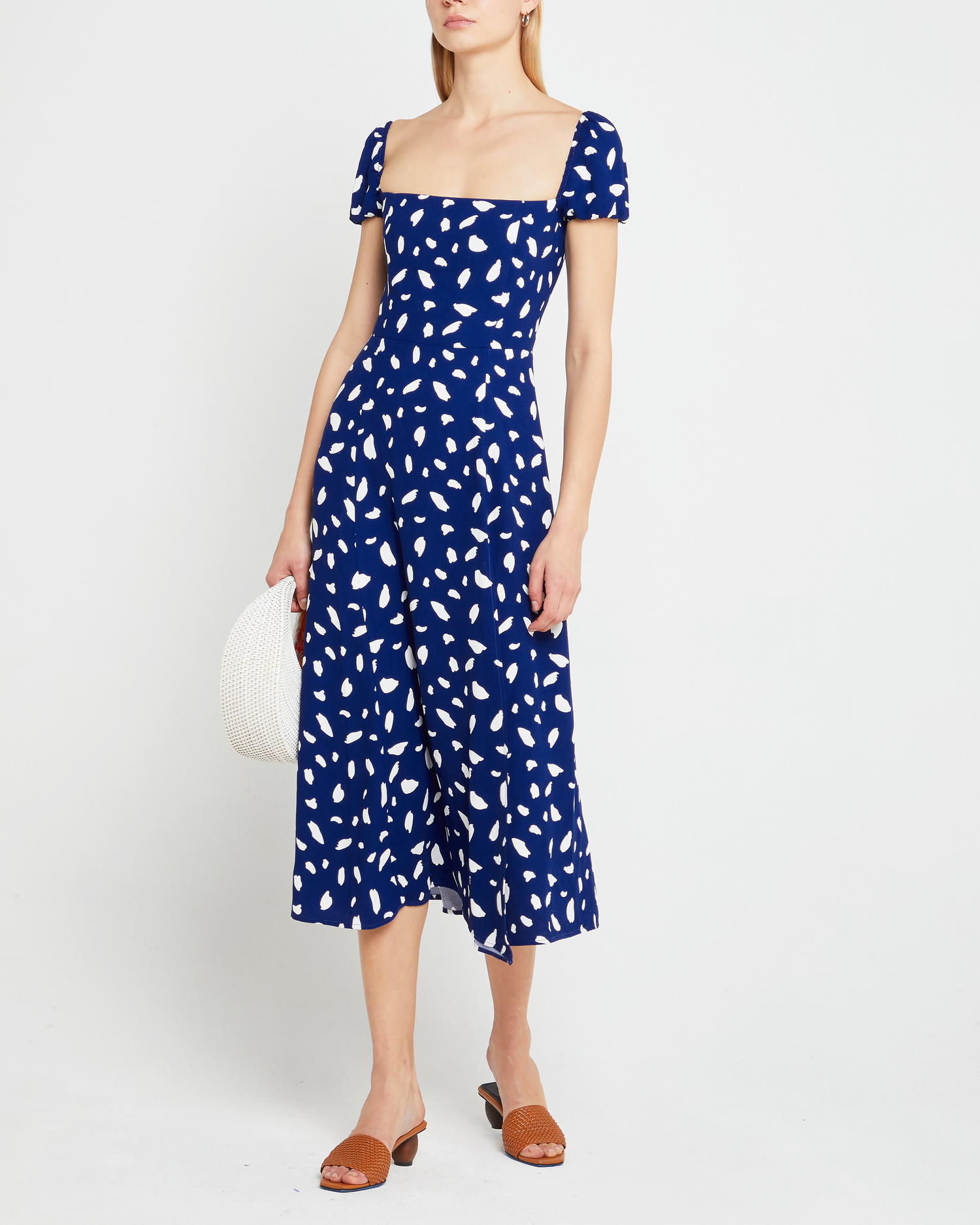 Fifth image of Cyra Dress, a blue midi dress, white polka dot, cap sleeves, side slit, square neckline