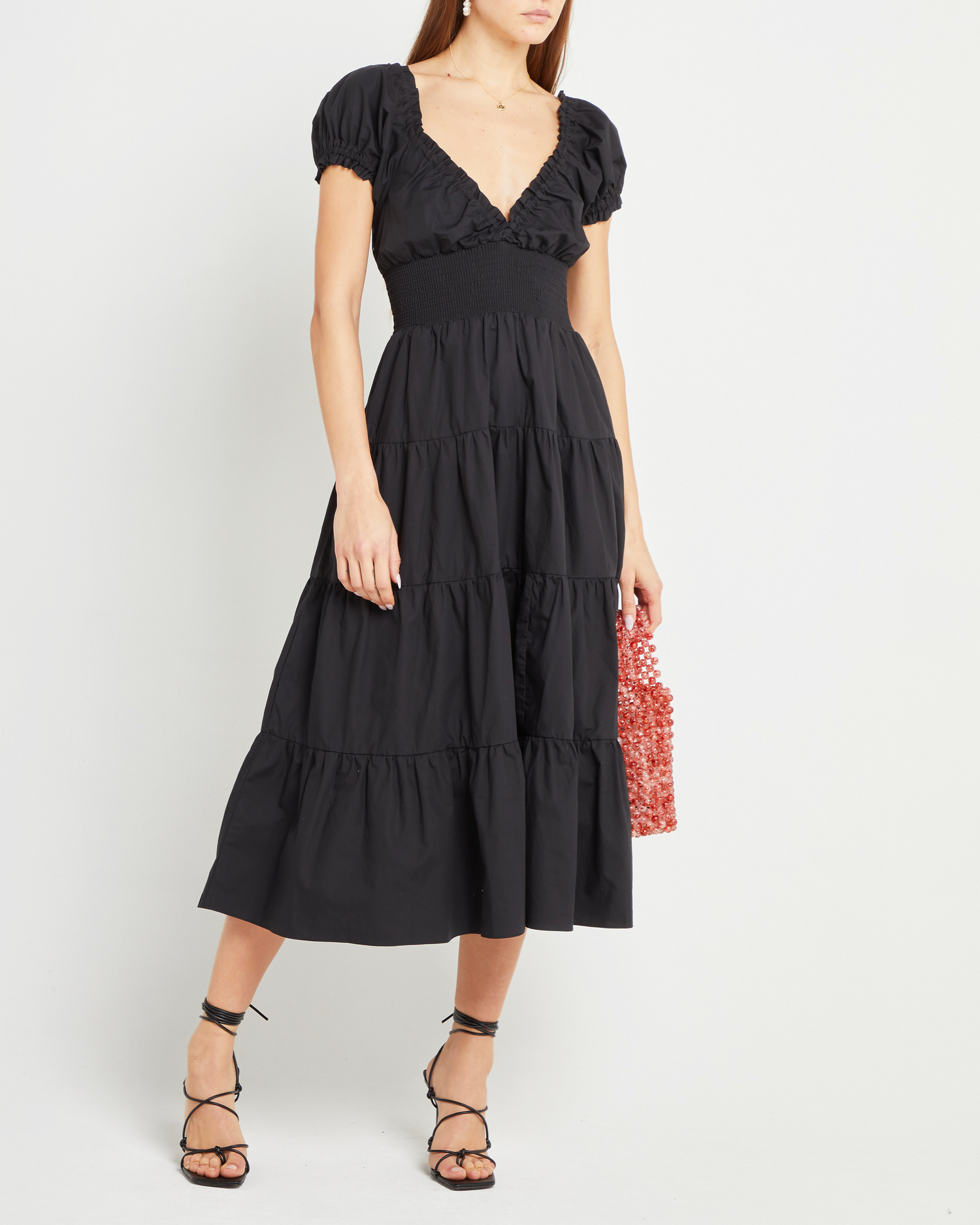 Fifth image of Cotton Delia Dress, a black midi dress, V-neck, ruffle, cap sleeves, short sleeves, tiered