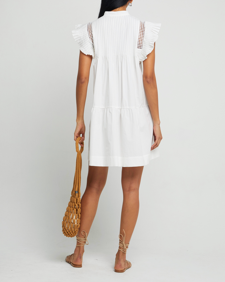 Second image of Callan Dress, a white mini dress, lace detail, ruffle cap sleeves, panel, pleats