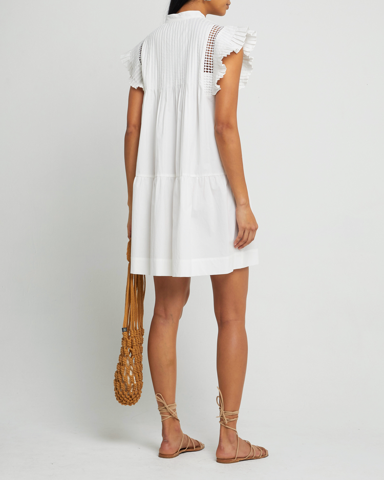 Fifth image of Callan Dress, a white mini dress, lace detail, ruffle cap sleeves, panel, pleats