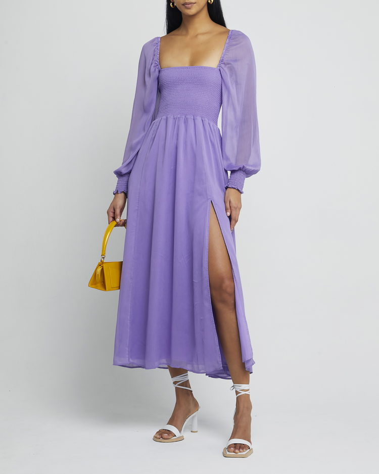 First image of Classic Smocked Maxi Dress, a purple maxi dress, side slit, long, sheer sleeves, puff sleeves, square neckline, smocked bodice