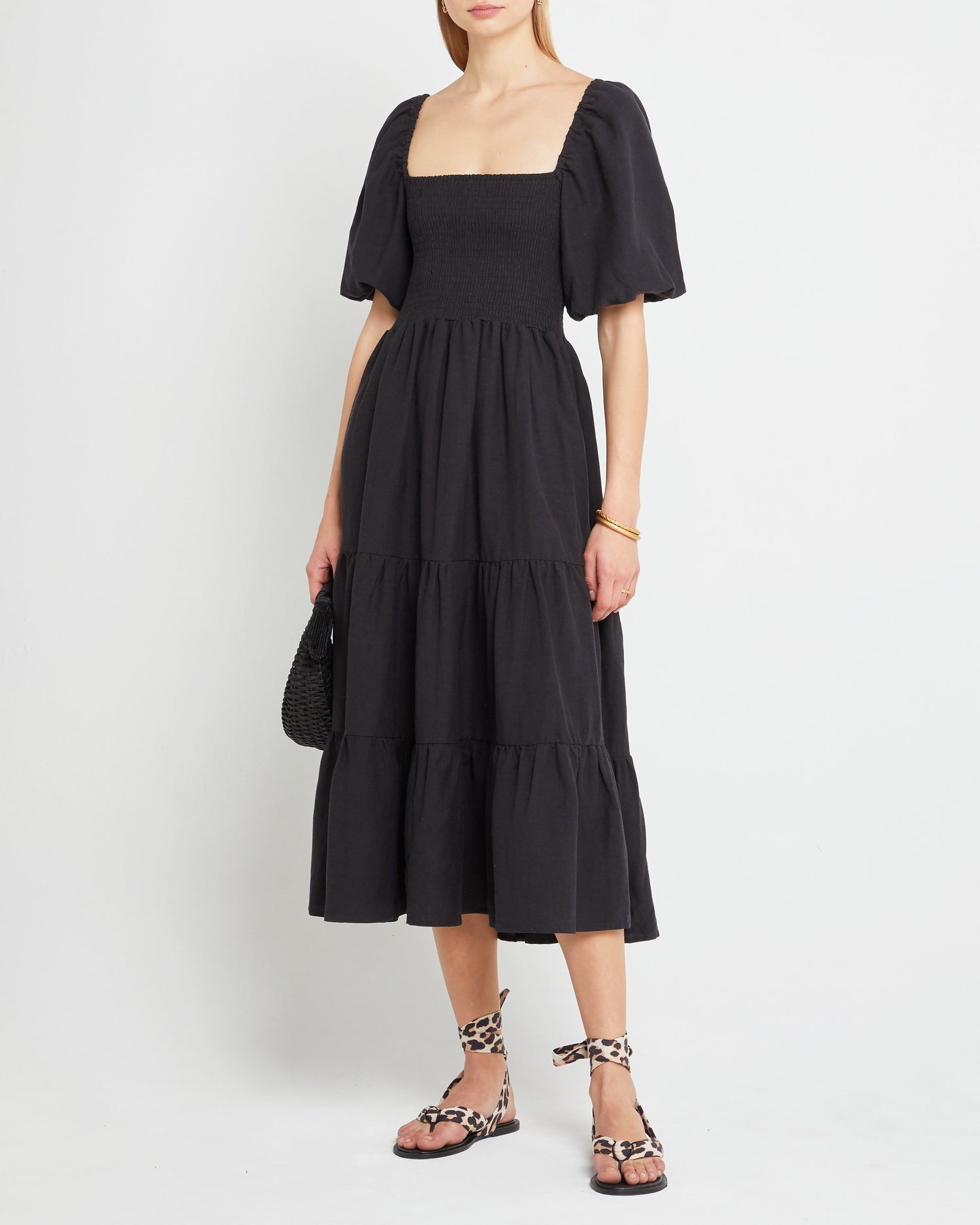 Third image of Hera Dress, a black midi dress, smocked, puff sleeves, cap sleeves