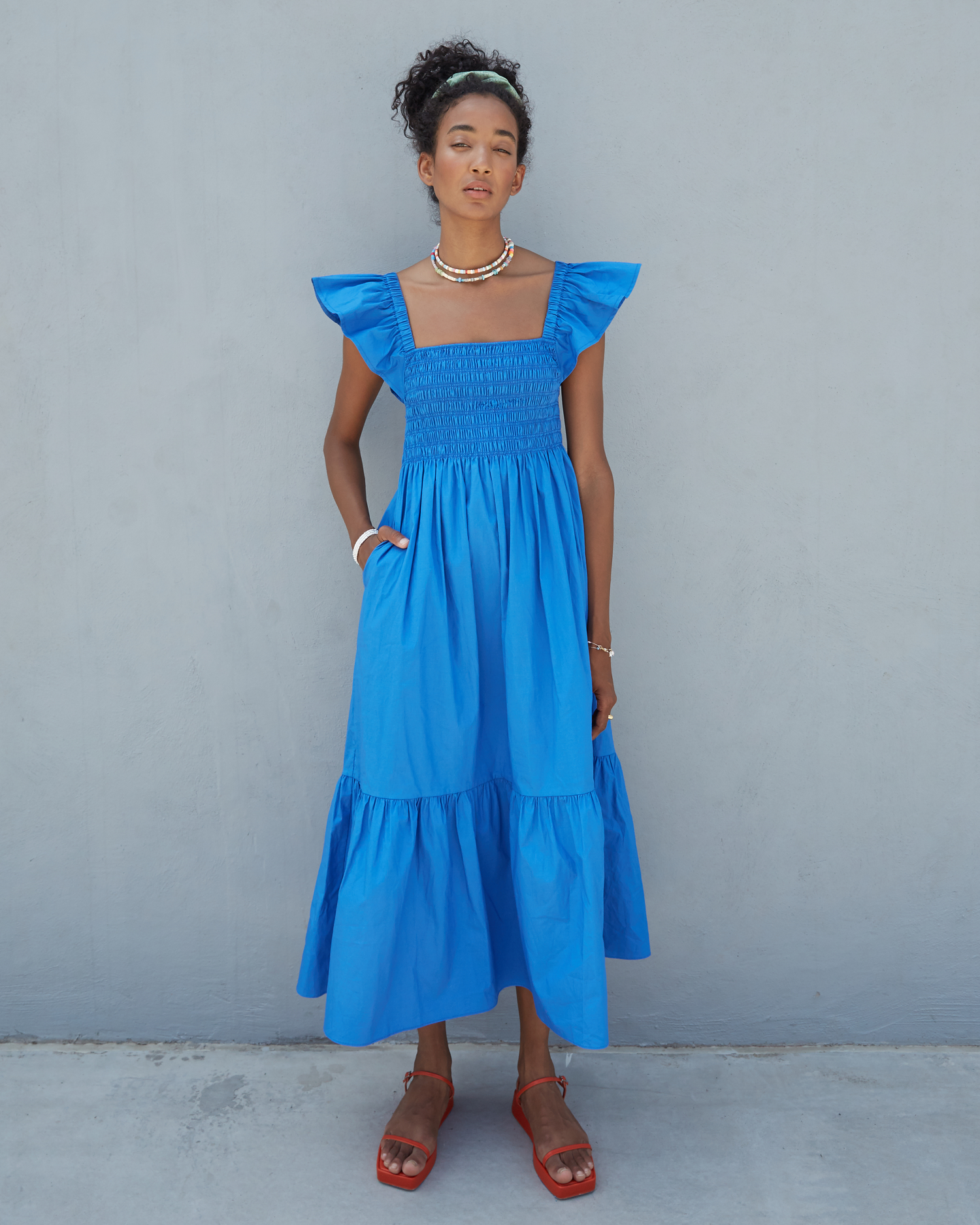 First image of Tuscany Dress, a blue maxi dress, smocked bodice, ruffled cap sleeves, pockets