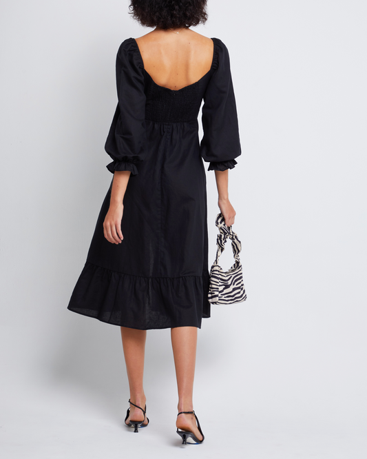 Second image of Aubrey Midi Dress, a black midi dress, long sleeves, puff sleeves, sweetheart neckline, side slit