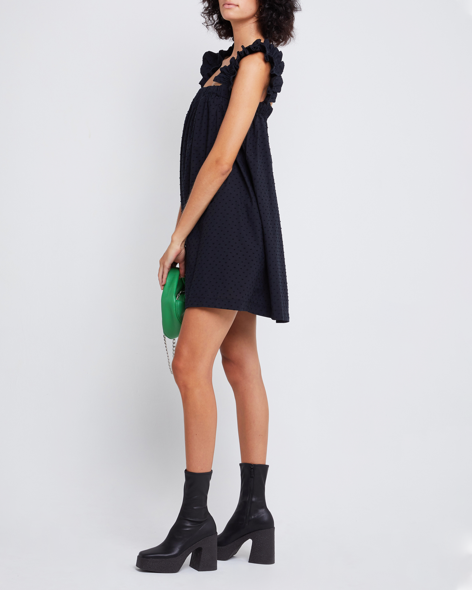 Third image of Nivia Dress, a black mini dress, ruffle sleeves, cap sleeves, flowy, relaxed