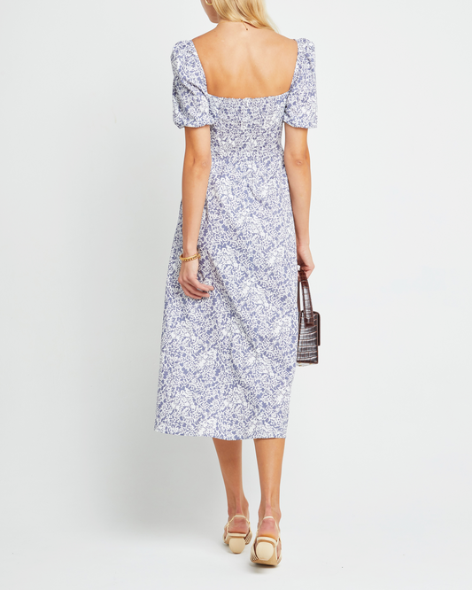 Second image of River Dress, a purple midi dress, square neckline, short puff sleeves, gathered bodice, floral print