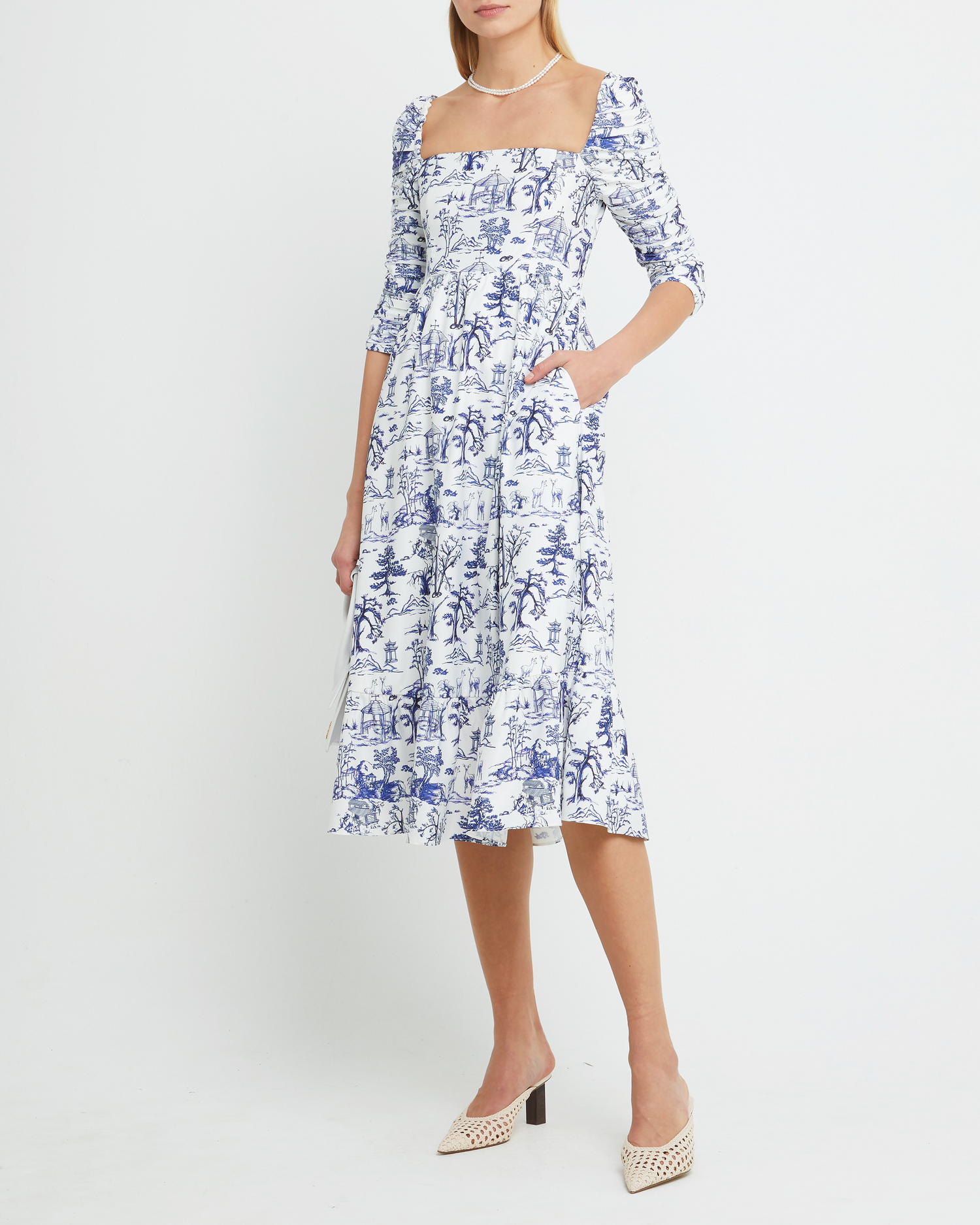 First image of Bonnie Dress, a blue midi dress, toile, pockets, ruched sleeves, square neckline, long sleeves, 3/4 sleeves