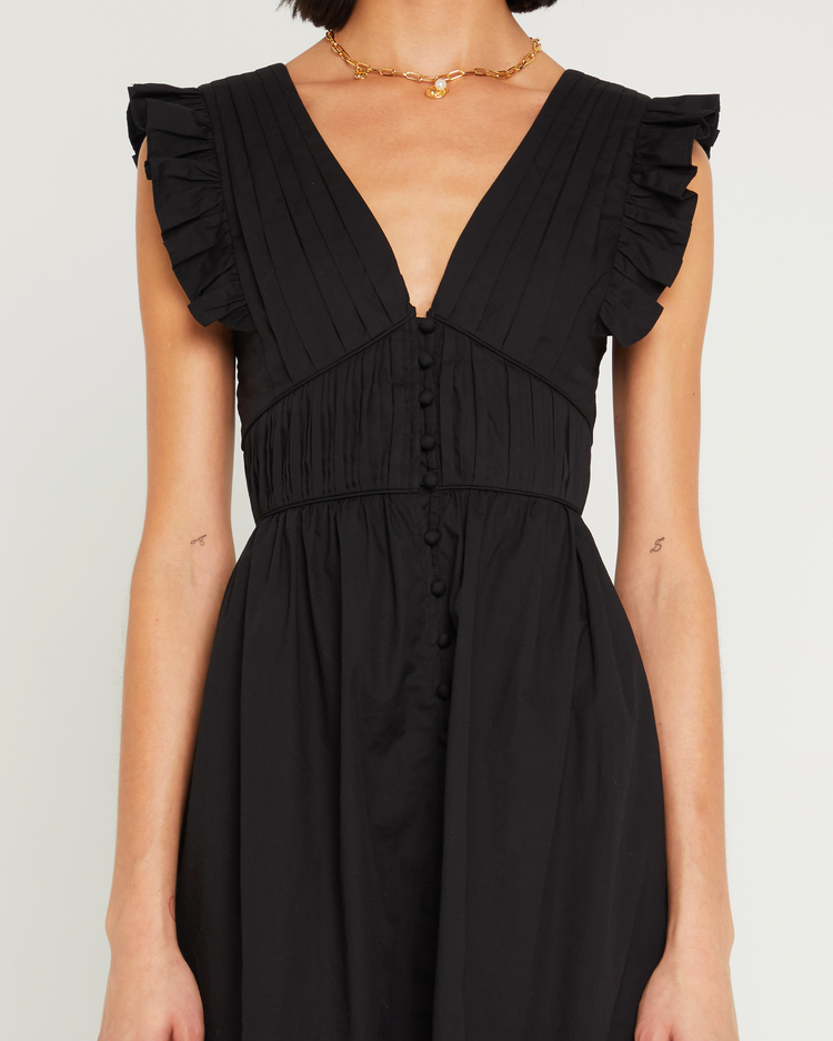 Sixth image of Stella Dress, a black midi dress, front buttons, ruffle sleeve, open back, tied ribbon, bow, tiered