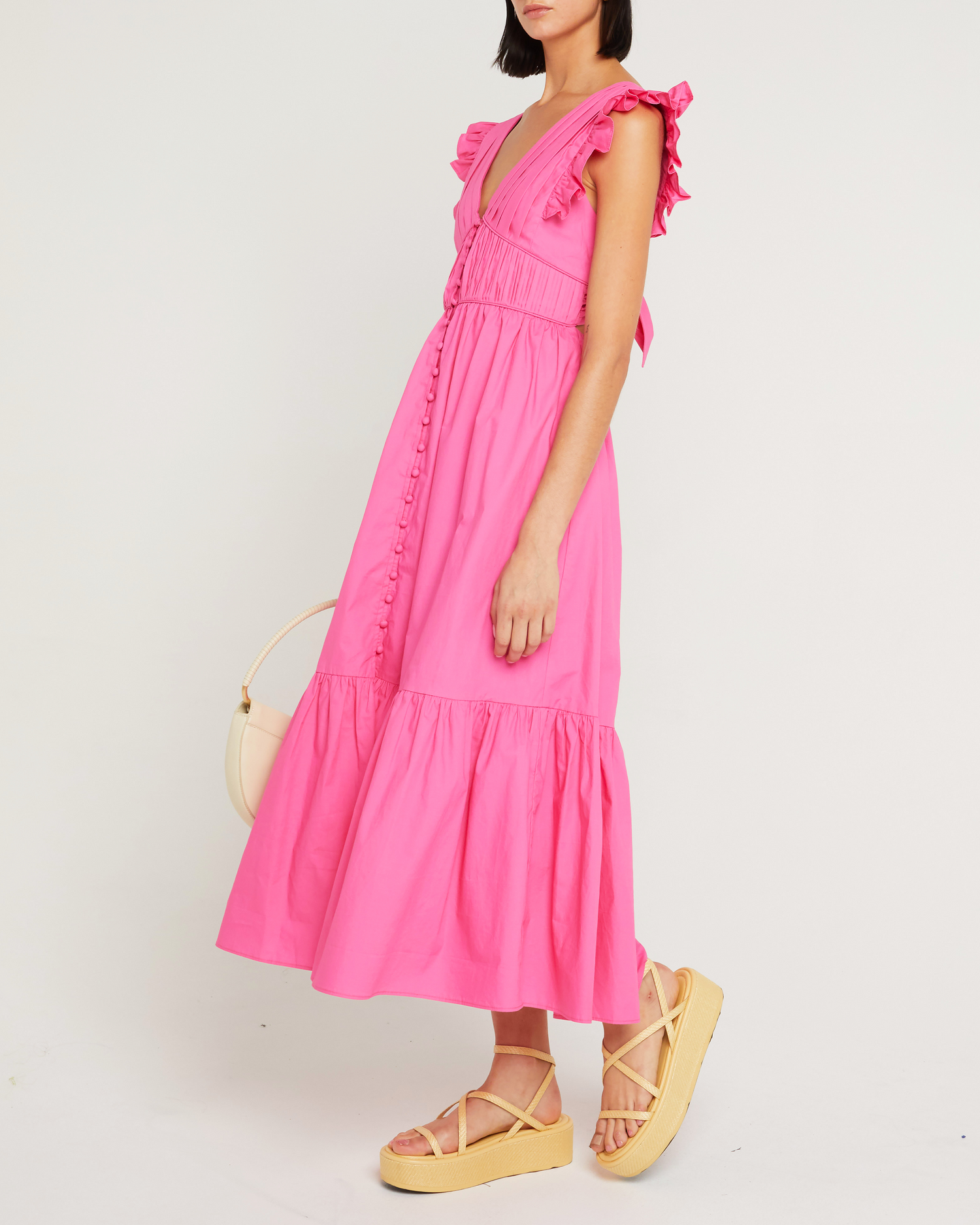 Third image of Stella Dress, a pink midi dress, open back, front buttons, ribbon tie, bow, ruffle sleeves