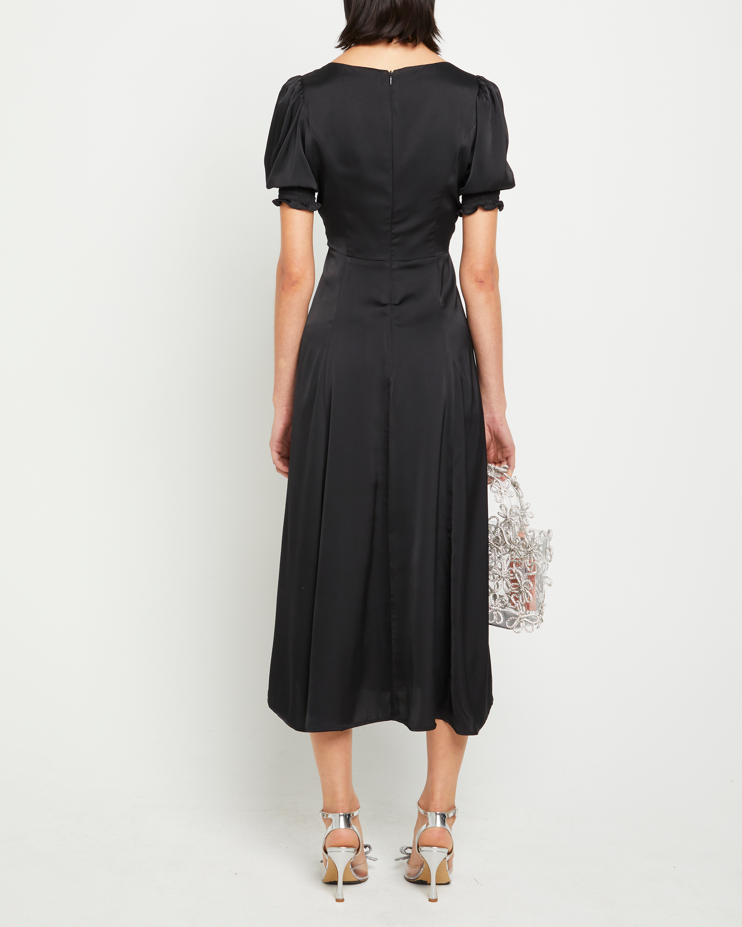 Second image of Melanie Dress, a black midi dress, side slit, silky, puff sleeve, cap sleeve, sweetheart neckline