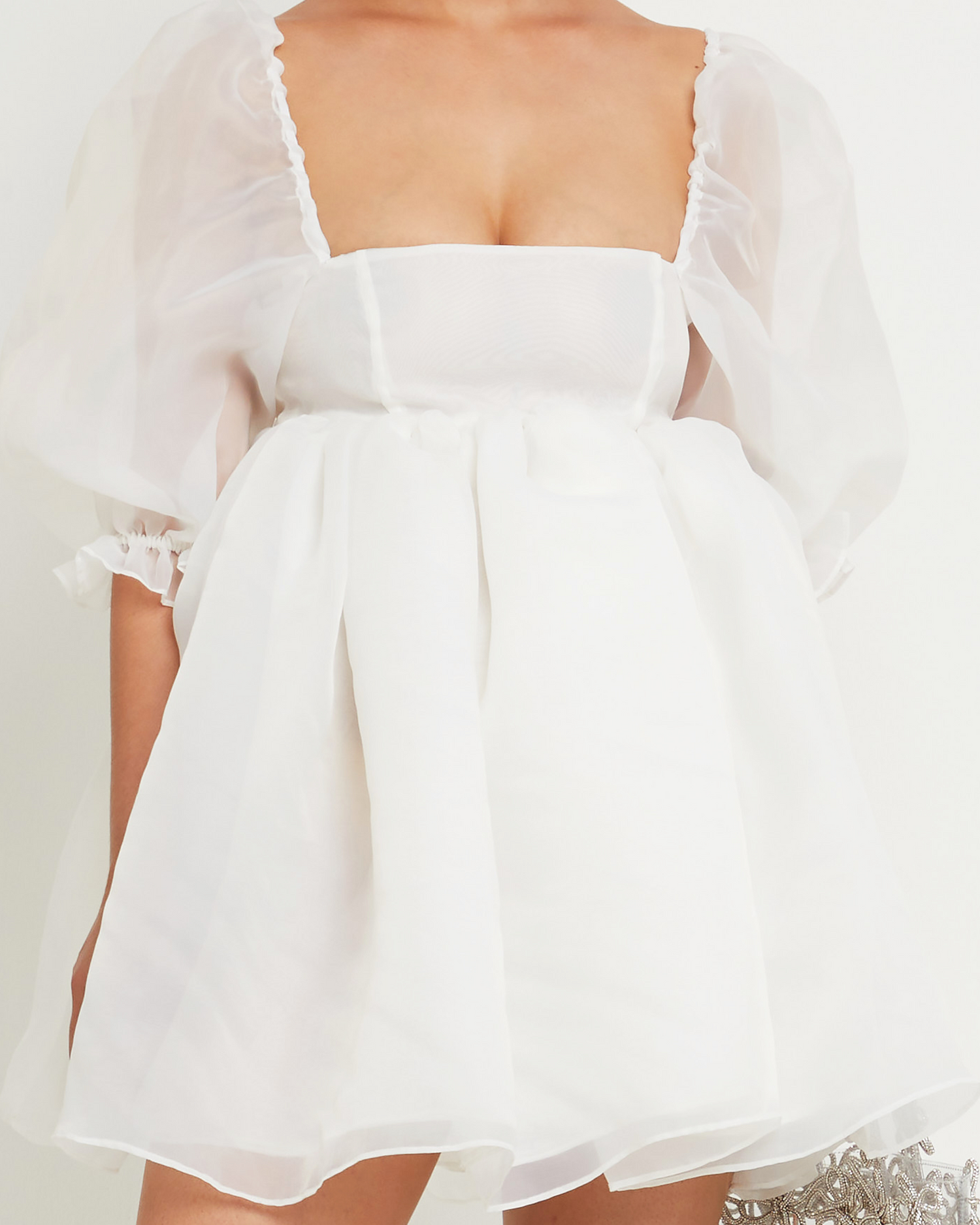 Fifth image of Cloud Mini Dress, a white mini wedding dress with square neckline, sheer puff sleeves, back zipper, babydoll sillhouette, and layered sheer fabric