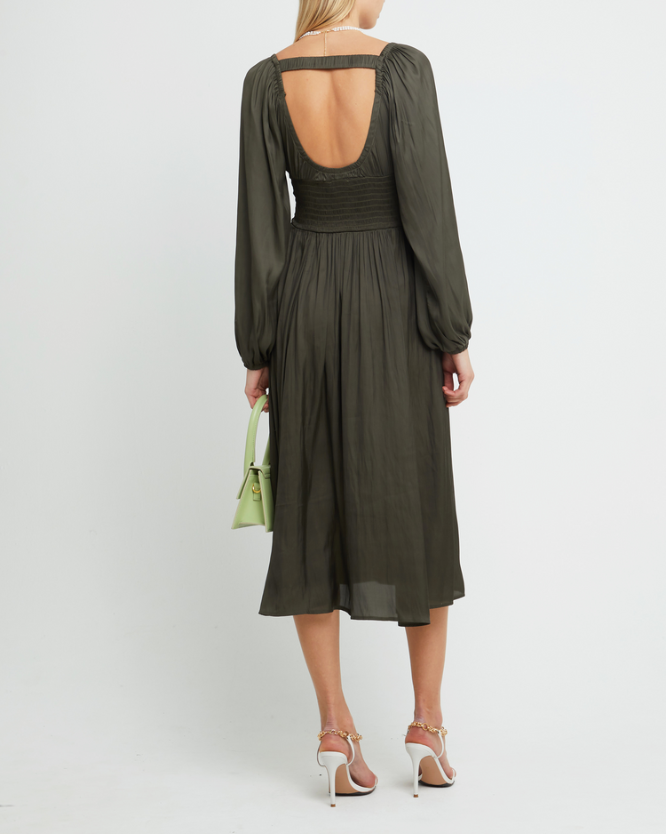 Second image of Nala Dress, a green midi dress, silky, smooth, thin, pleated, smocked, V-neck, side slit