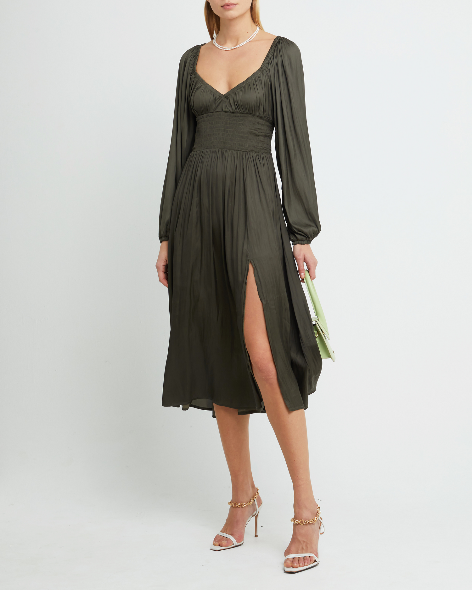 First image of Nala Dress, a green midi dress, silky, smooth, thin, pleated, smocked, V-neck, side slit