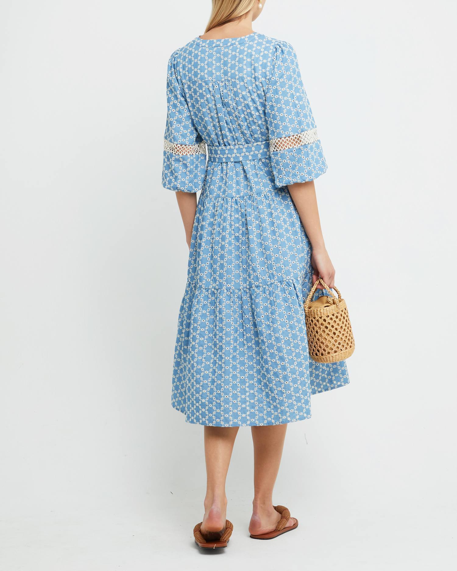 Second image of Haven Dress, a blue midi dress, lace detail, eyelet, waist tie, bow, wrap dress, puff sleeves