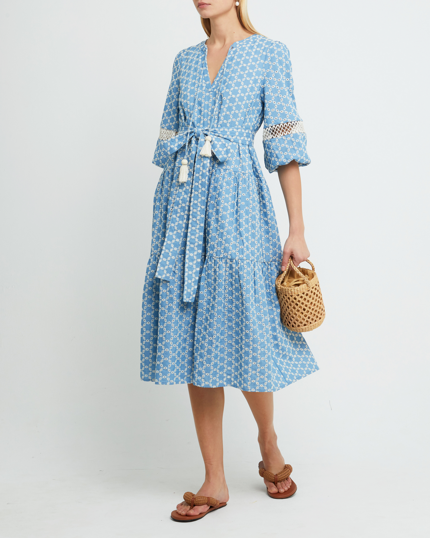 First image of Haven Dress, a blue midi dress, lace detail, eyelet, waist tie, bow, wrap dress, puff sleeves
