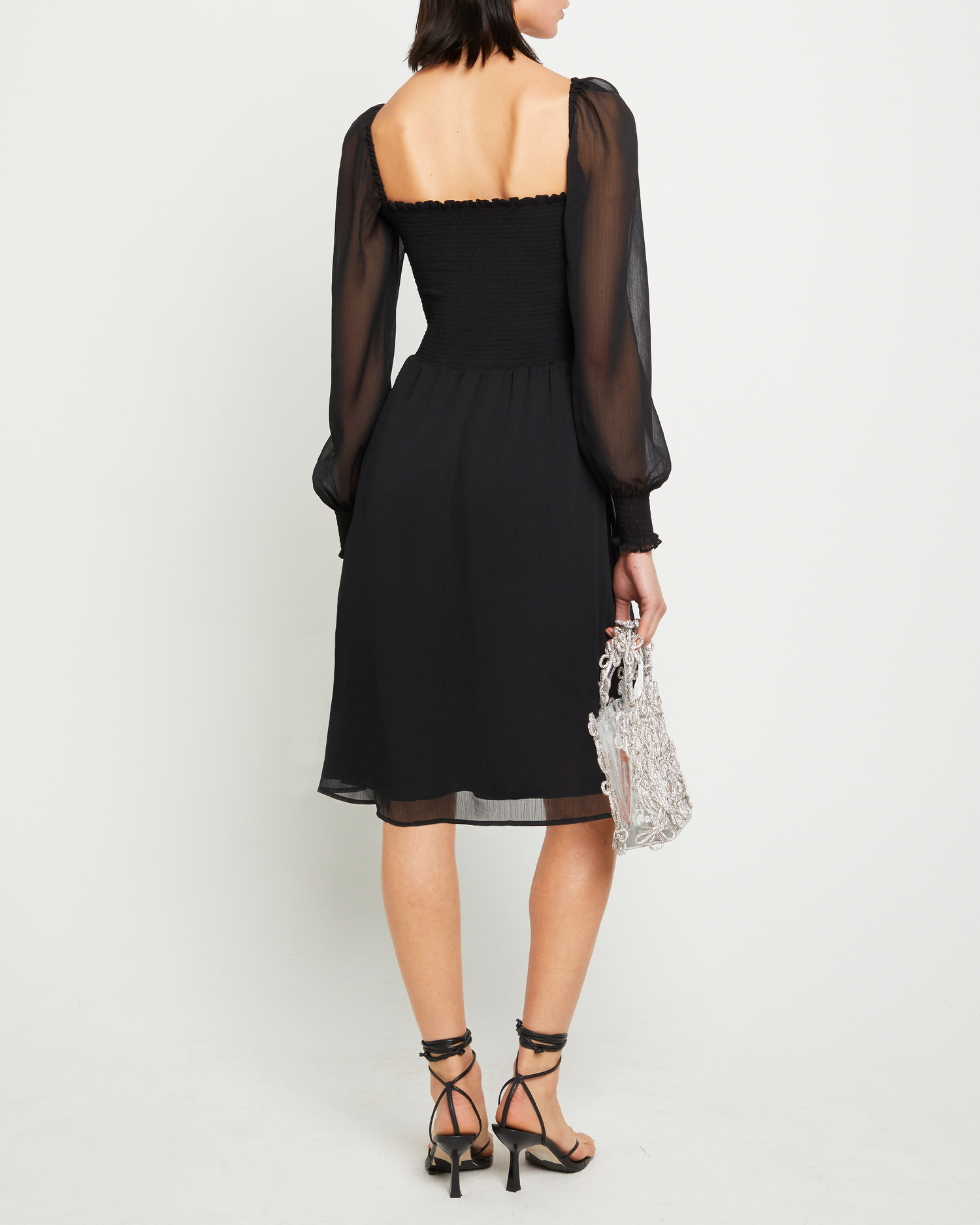 Fifth image of Classic Smocked Midi Dress, a black midi dress, side slit, long, sheer sleeves, puff sleeves, square neckline, smocked bodice