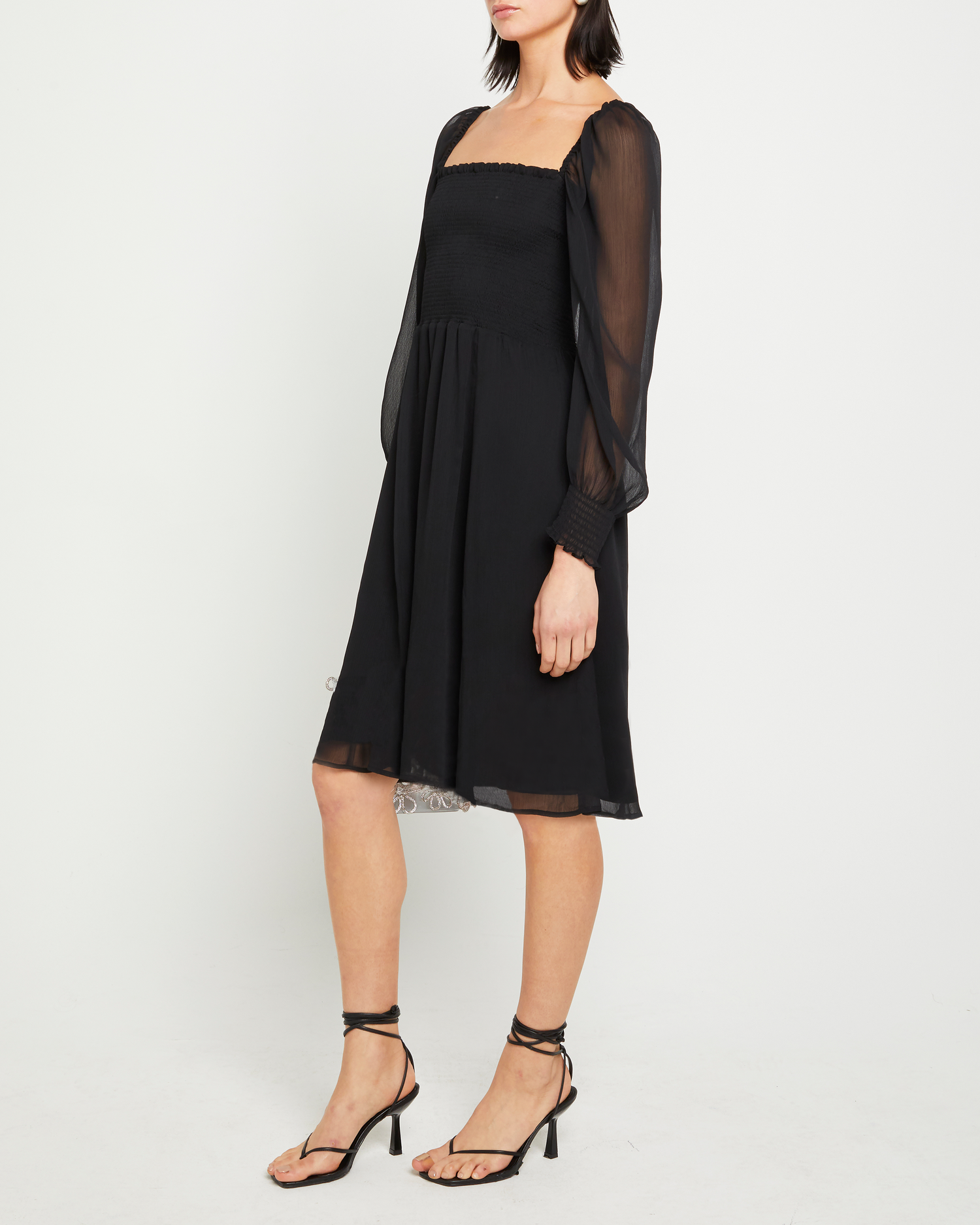 Third image of Classic Smocked Midi Dress, a black midi dress, side slit, long, sheer sleeves, puff sleeves, square neckline, smocked bodice