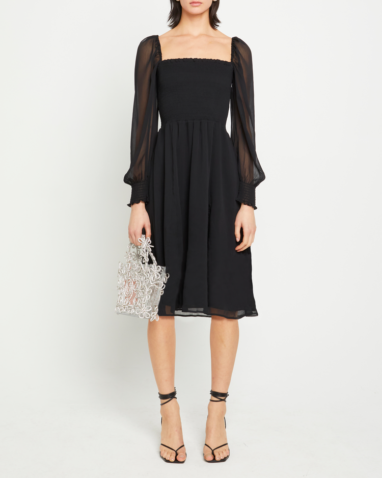 First image of Classic Smocked Midi Dress, a black midi dress, side slit, long, sheer sleeves, puff sleeves, square neckline, smocked bodice