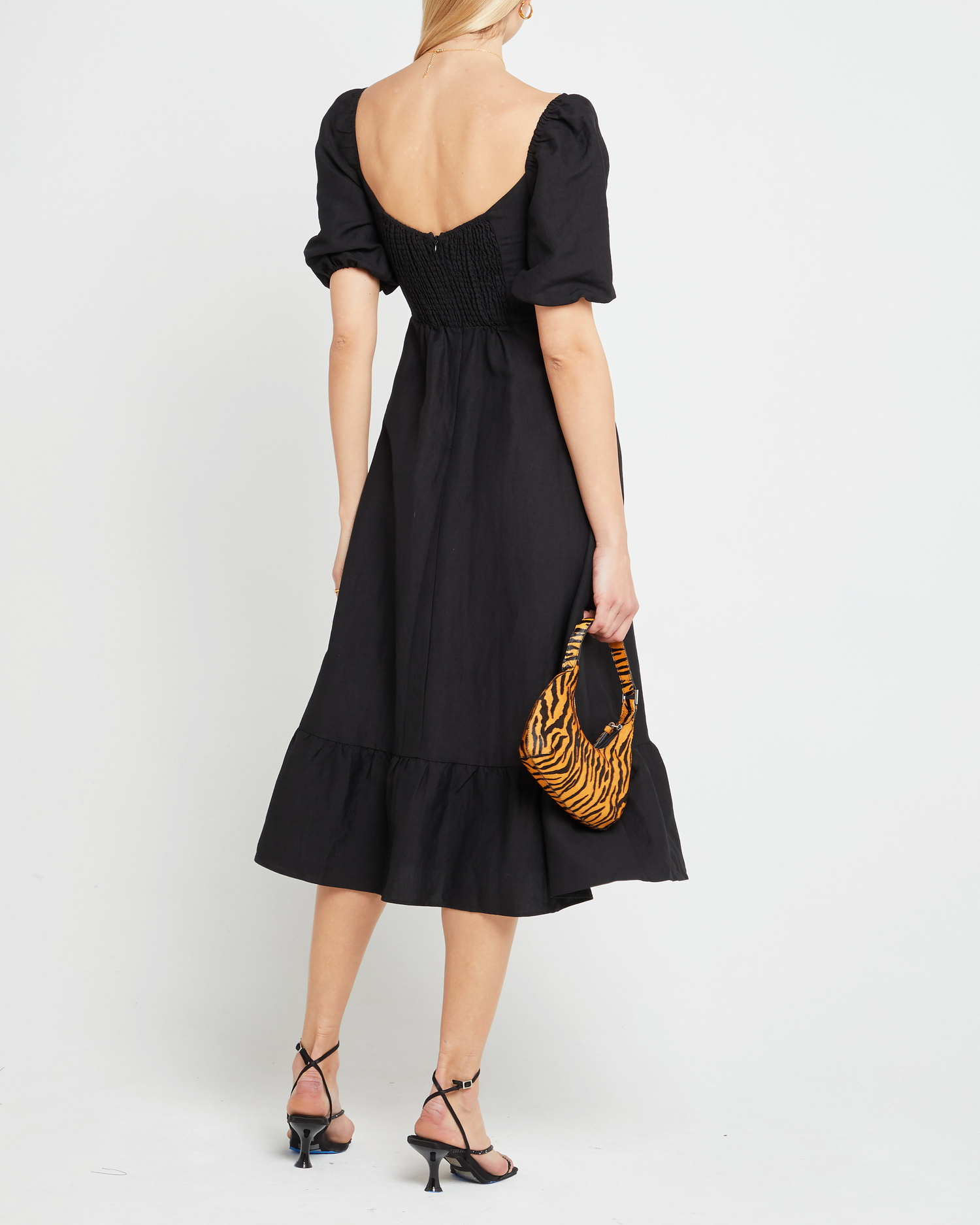 Second image of Violetta Midi Dress, a black midi dress, sweetheart neckline, short sleeves, puff sleeves, side slit